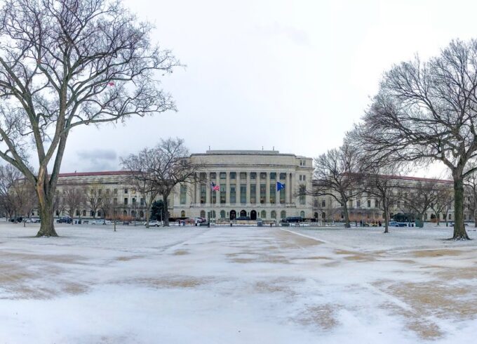 A photo of the Whitten Building of the USDA headquarters in Washington with snow in the foreground.