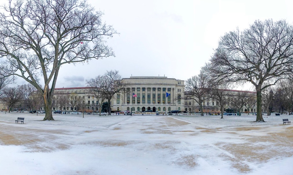 A photo of the Whitten Building of the USDA headquarters in Washington with snow in the foreground.