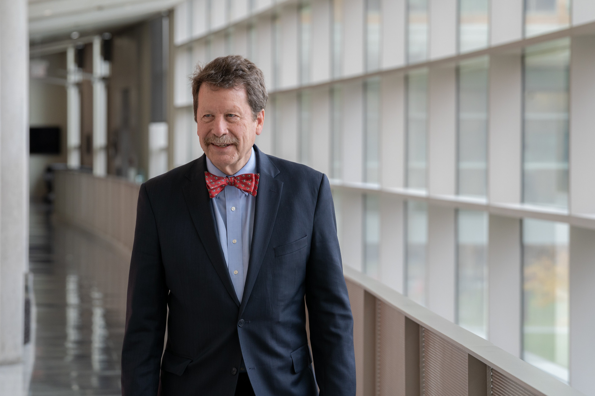 FDA Commissioner Robert Califf stands against a wall of windows at the agency. FDA photo.