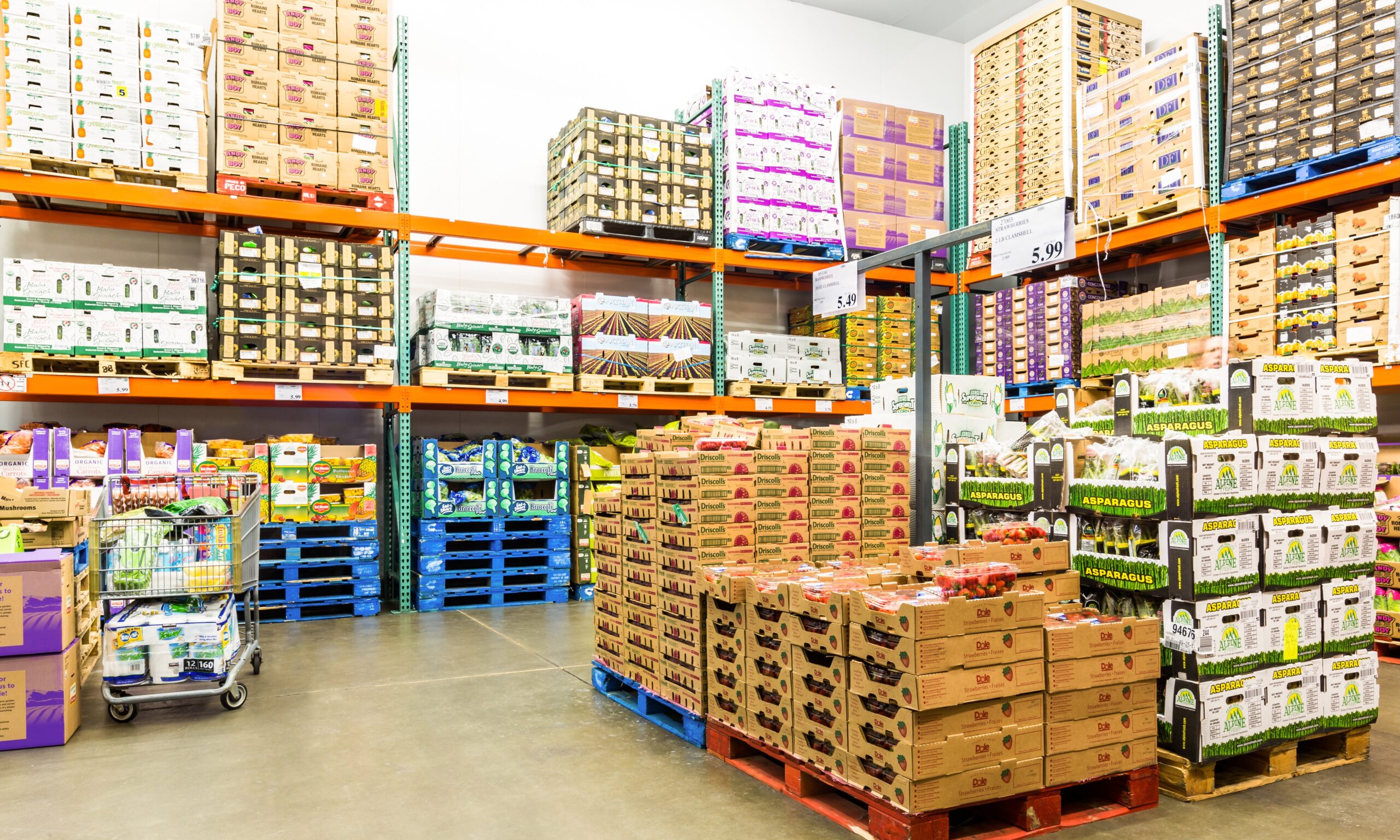 A photograph of a Costco cooler room full of pallets with produce in them.