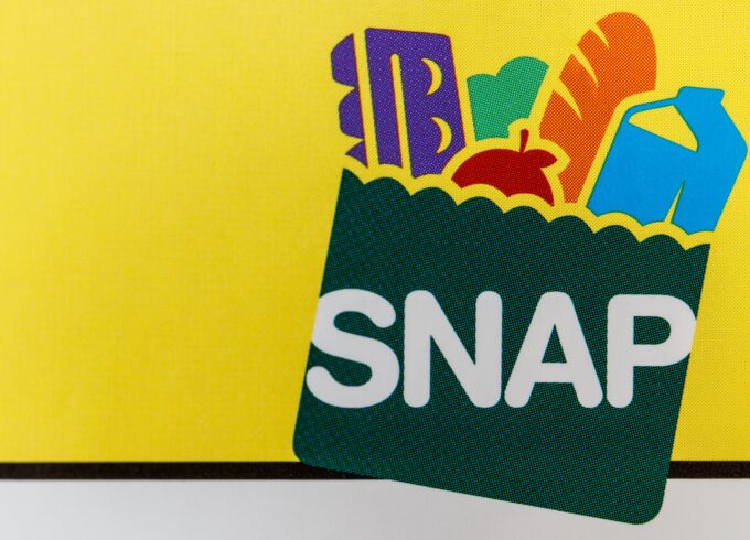 The USDA's SNAP logo against a yellow backdrop. SNAP stands for Supplemental Nutrition Assistance Program.